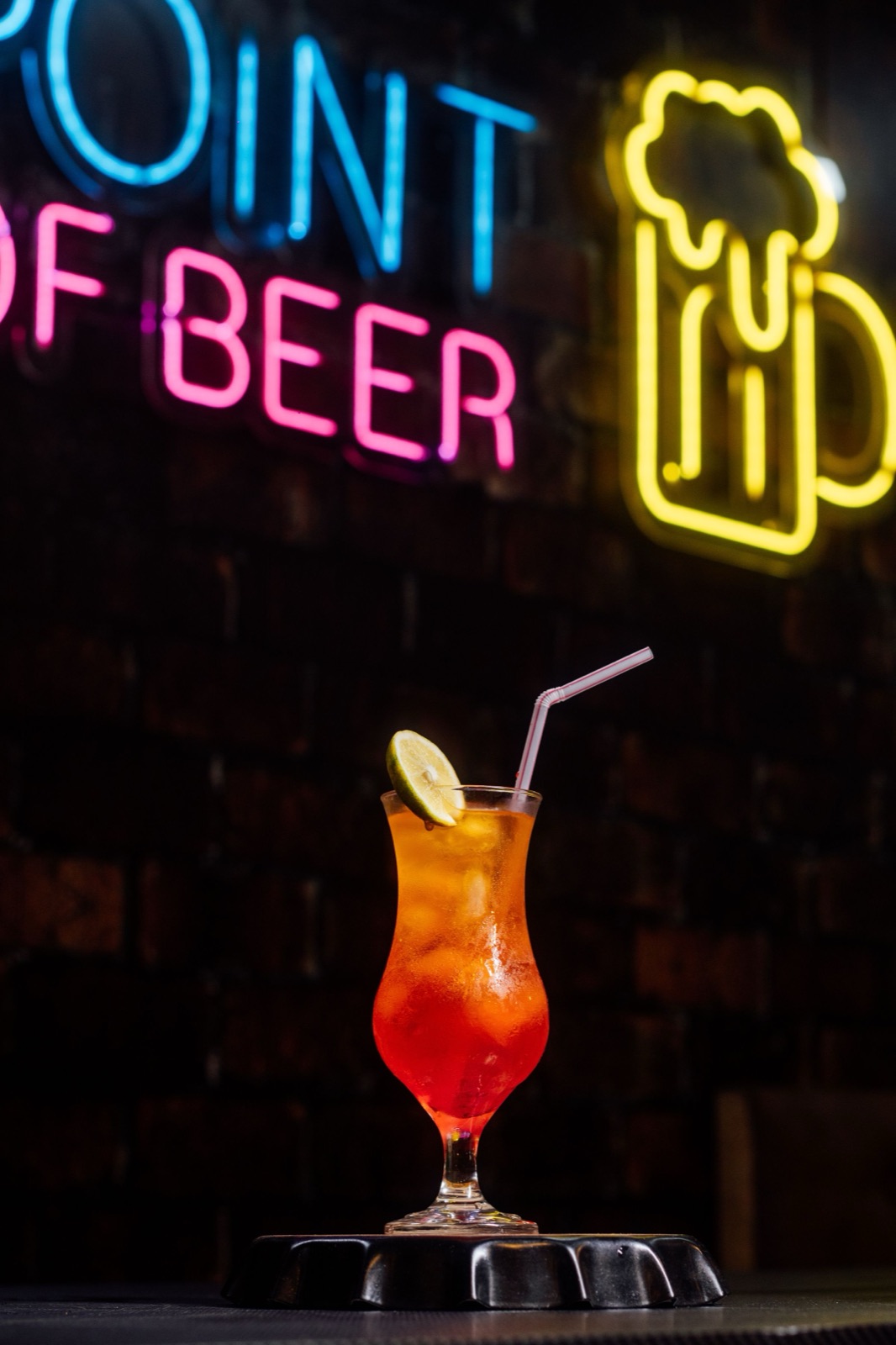 Bar with drinks lined up under neon light